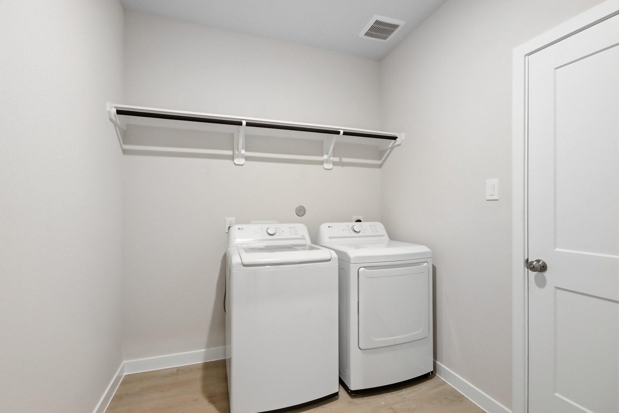 A room with a washer and dryer.