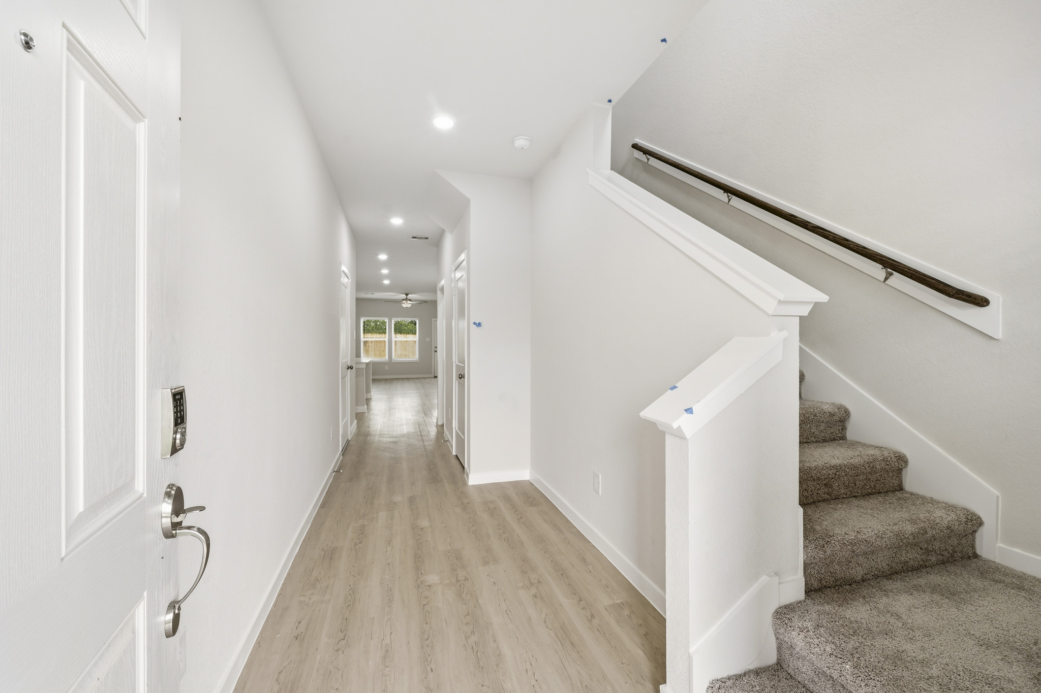 A hallway with a wood floor.