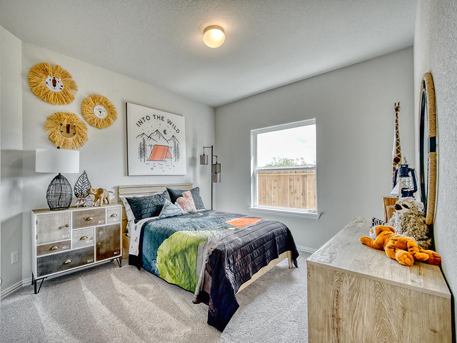 A bedroom with a bed and a table.