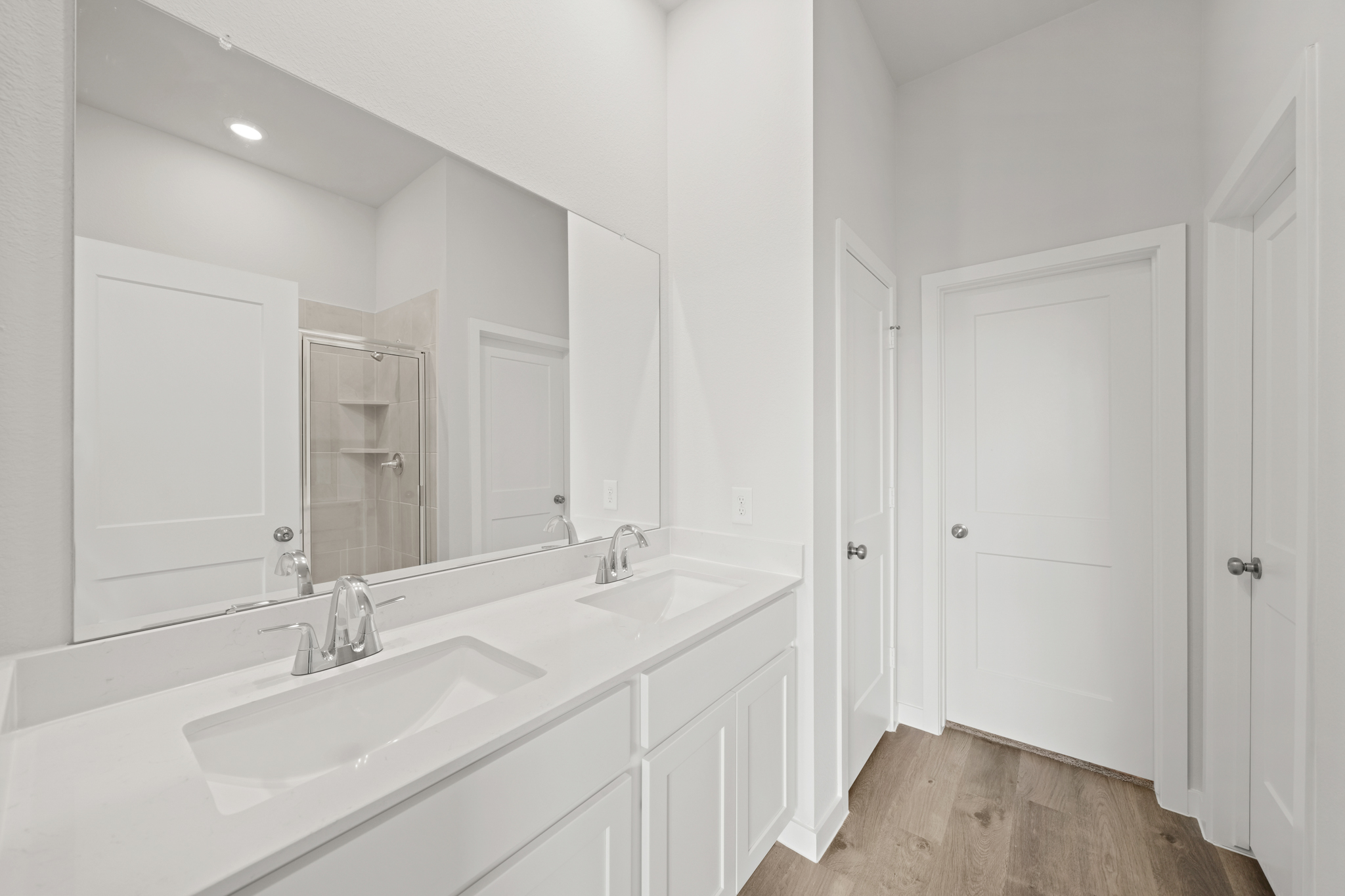 A bathroom with white cabinets.