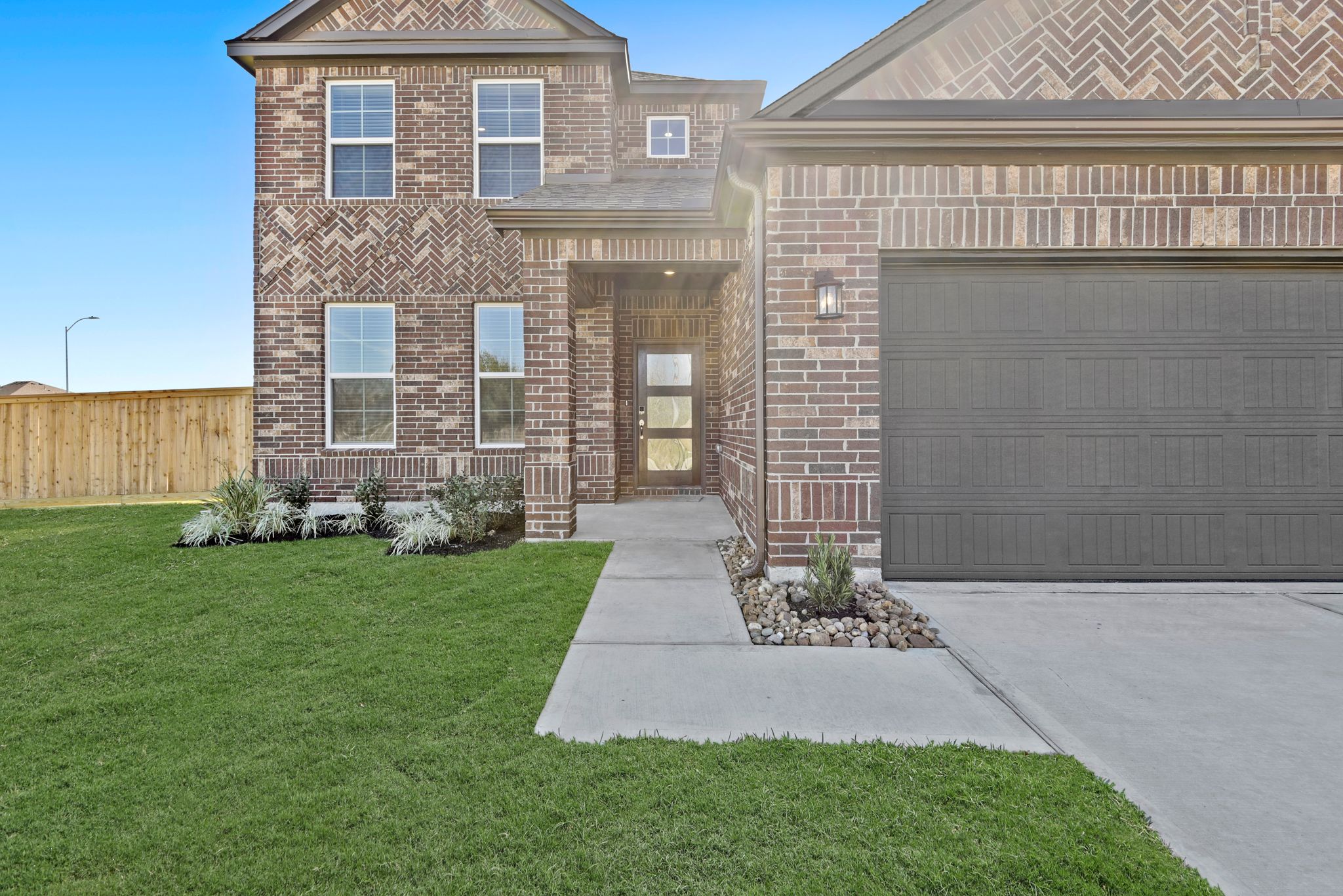A brick building with a green lawn.