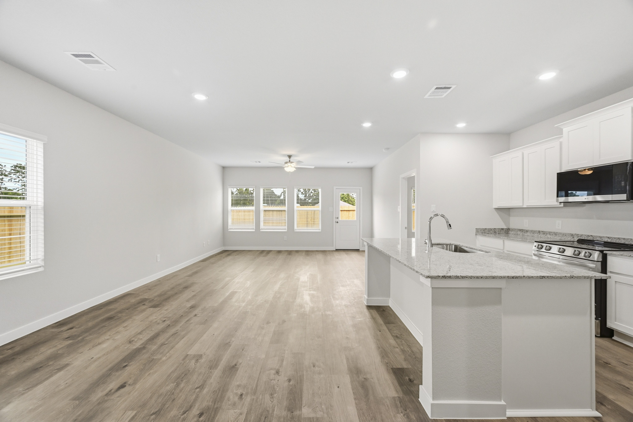 A kitchen with white cabinets.