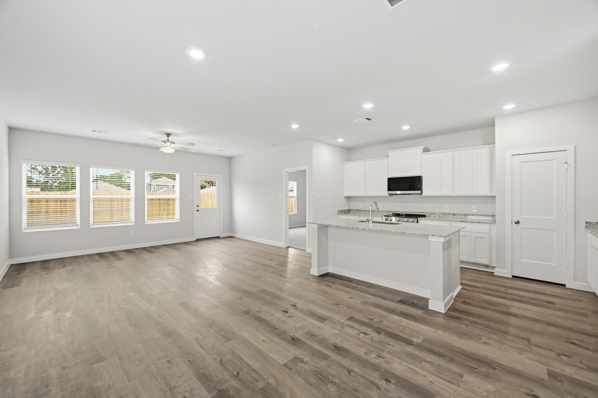 A large kitchen with white cabinets.