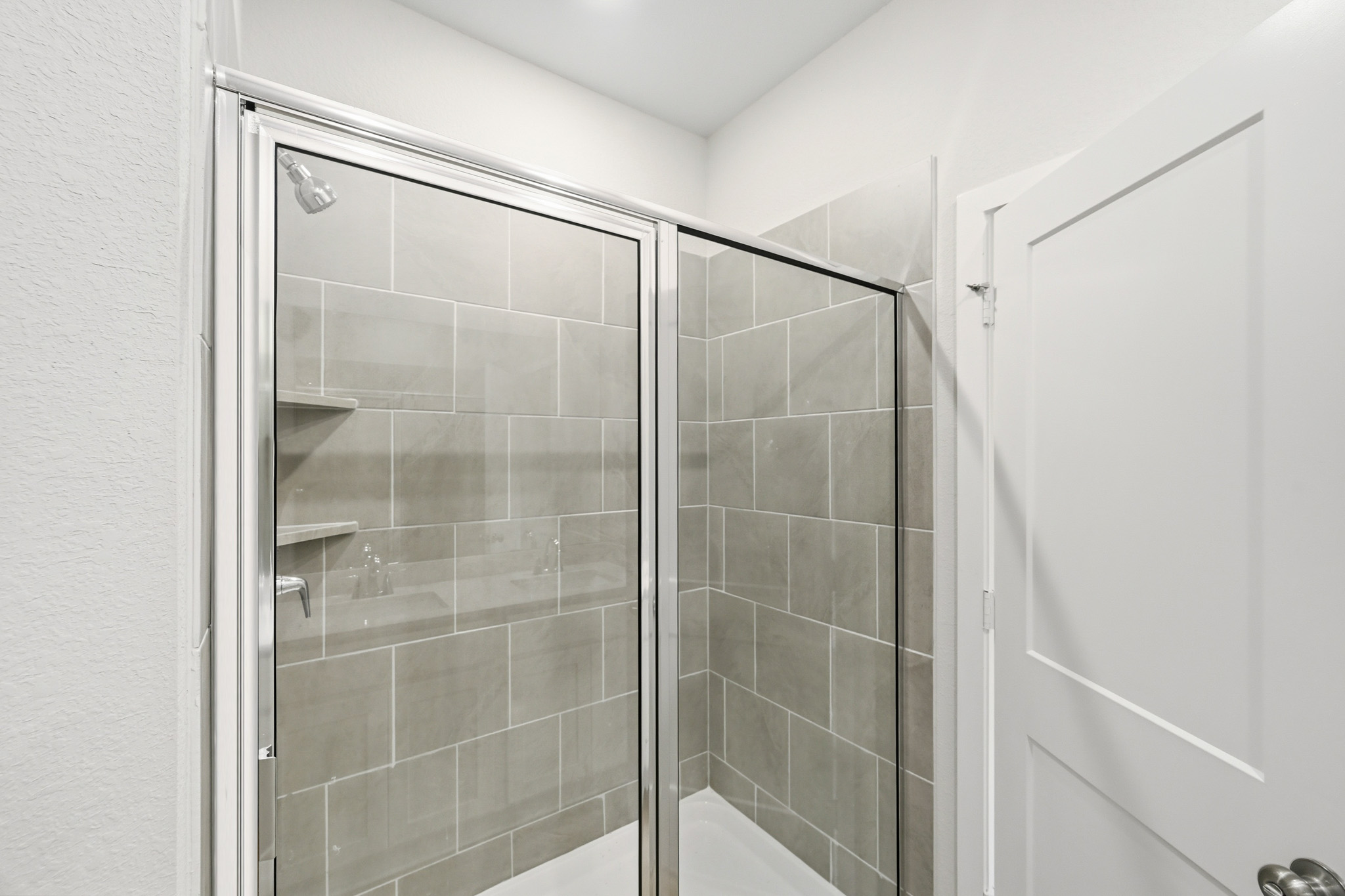 A shower with glass doors.