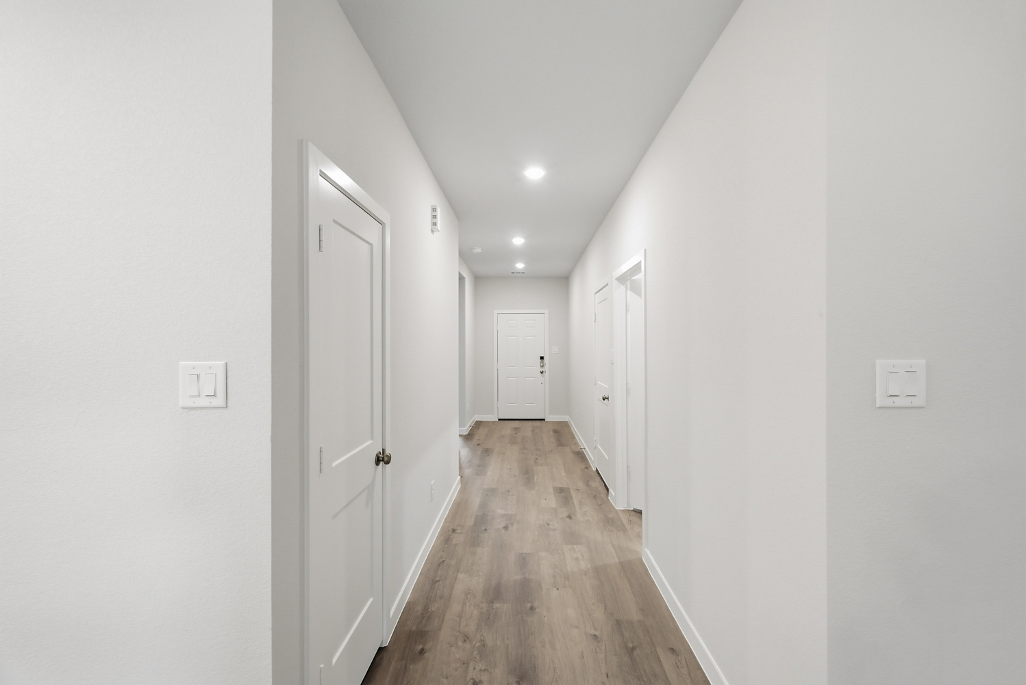 A hallway with white doors.