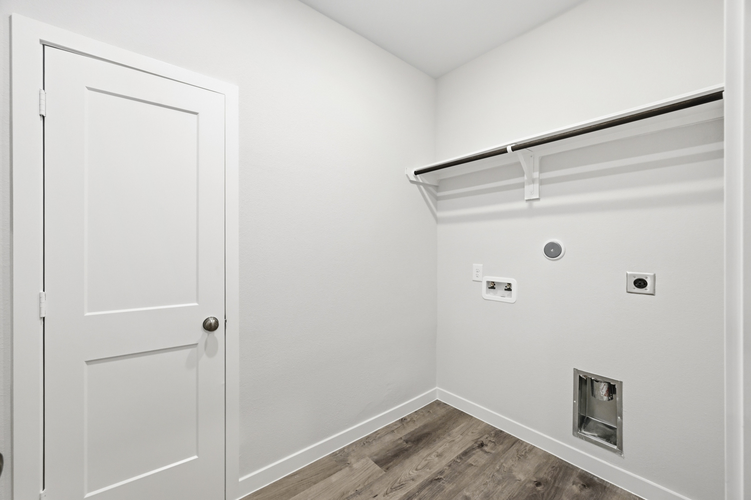 A white wall with a white door.