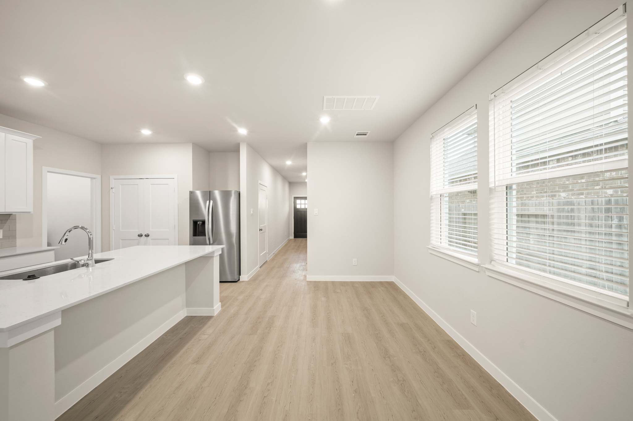 A large kitchen with white cabinets.