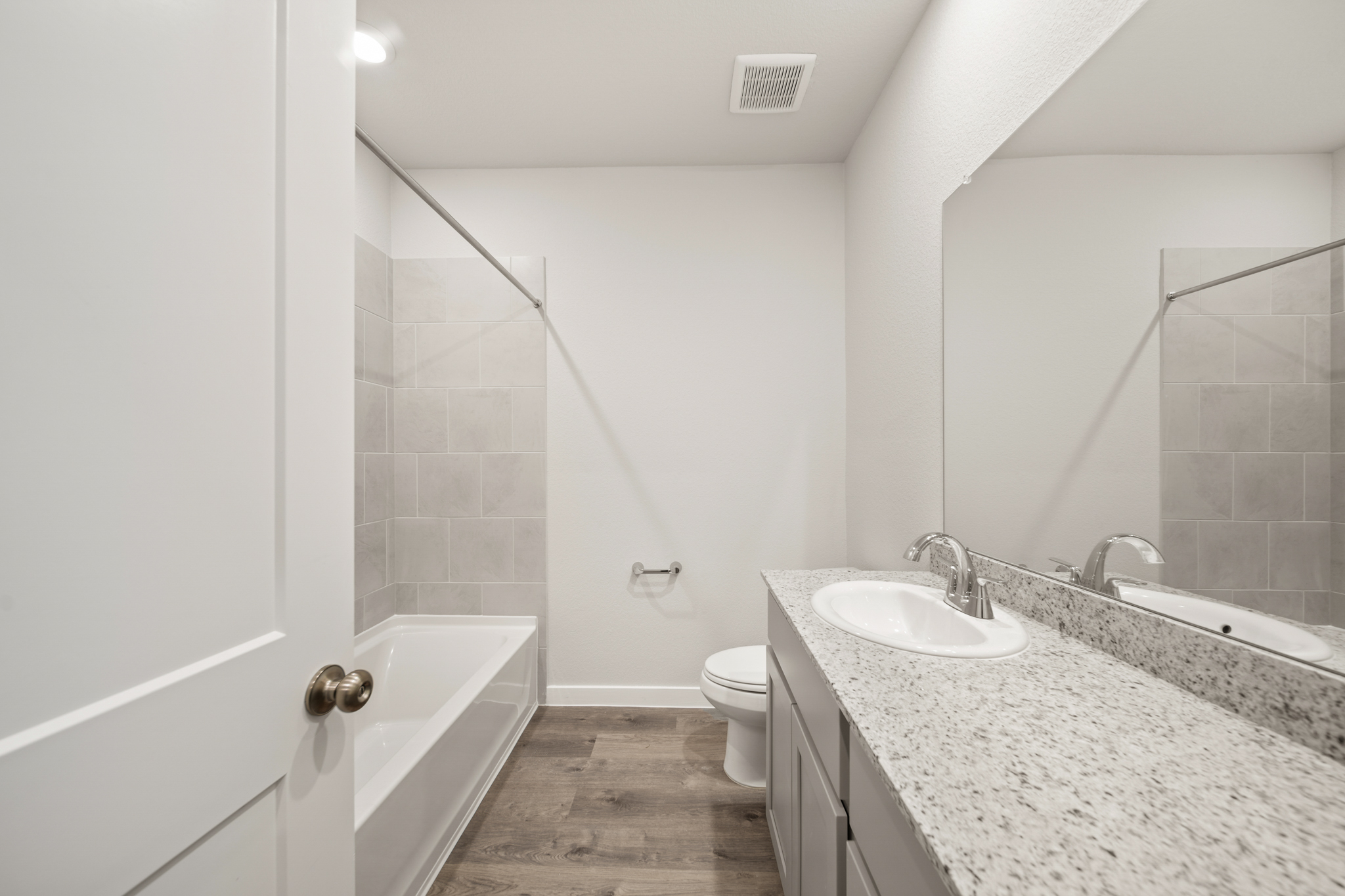 A bathroom with a marble countertop.