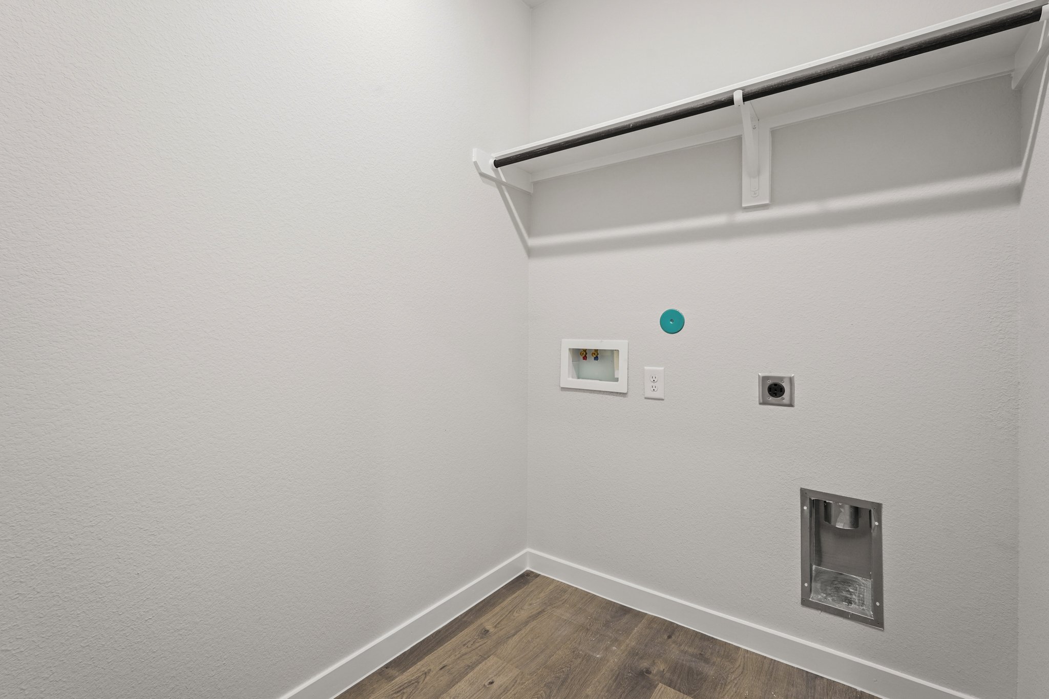 A white wall with a light fixture.