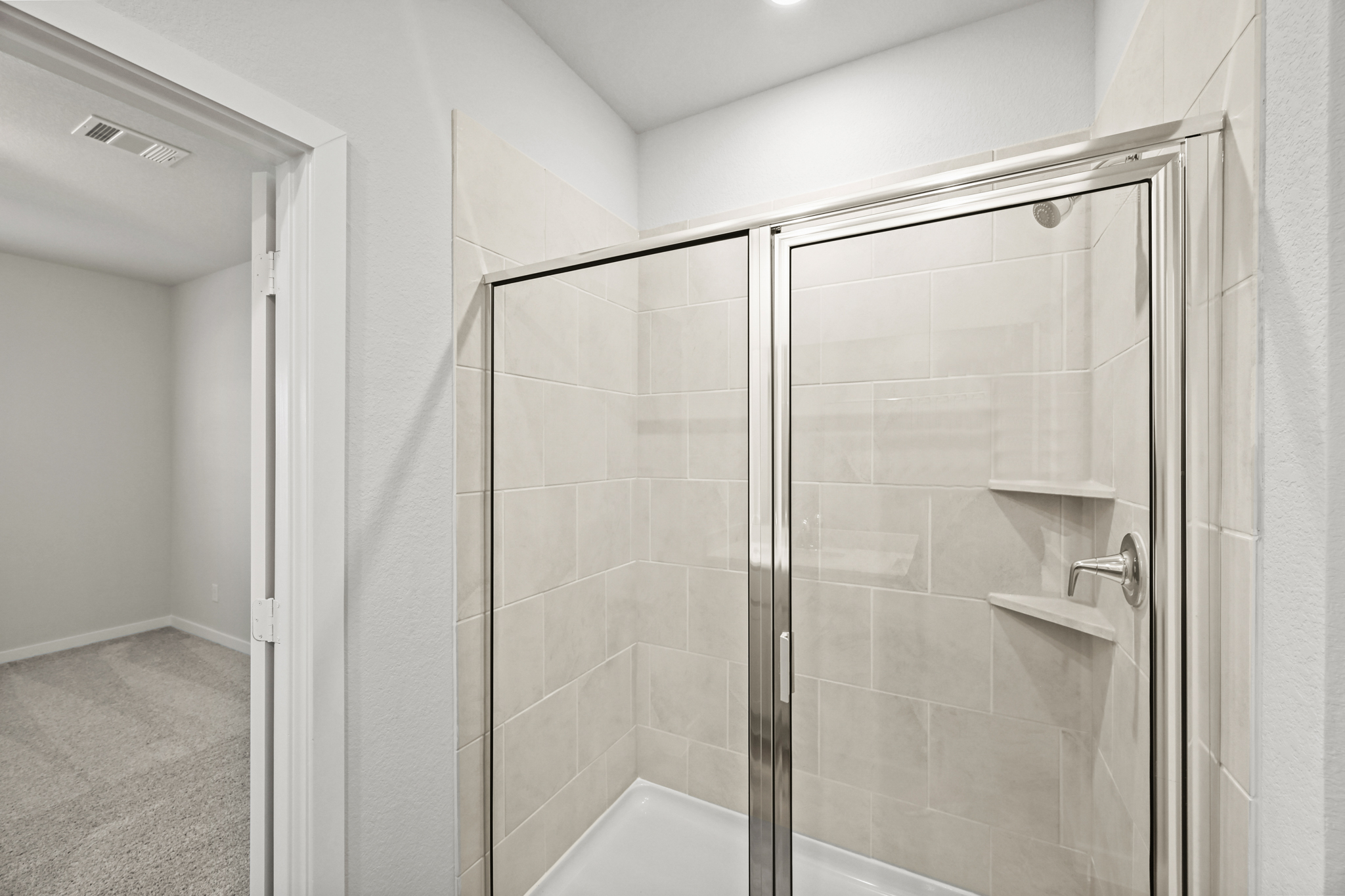 A shower with a glass door.