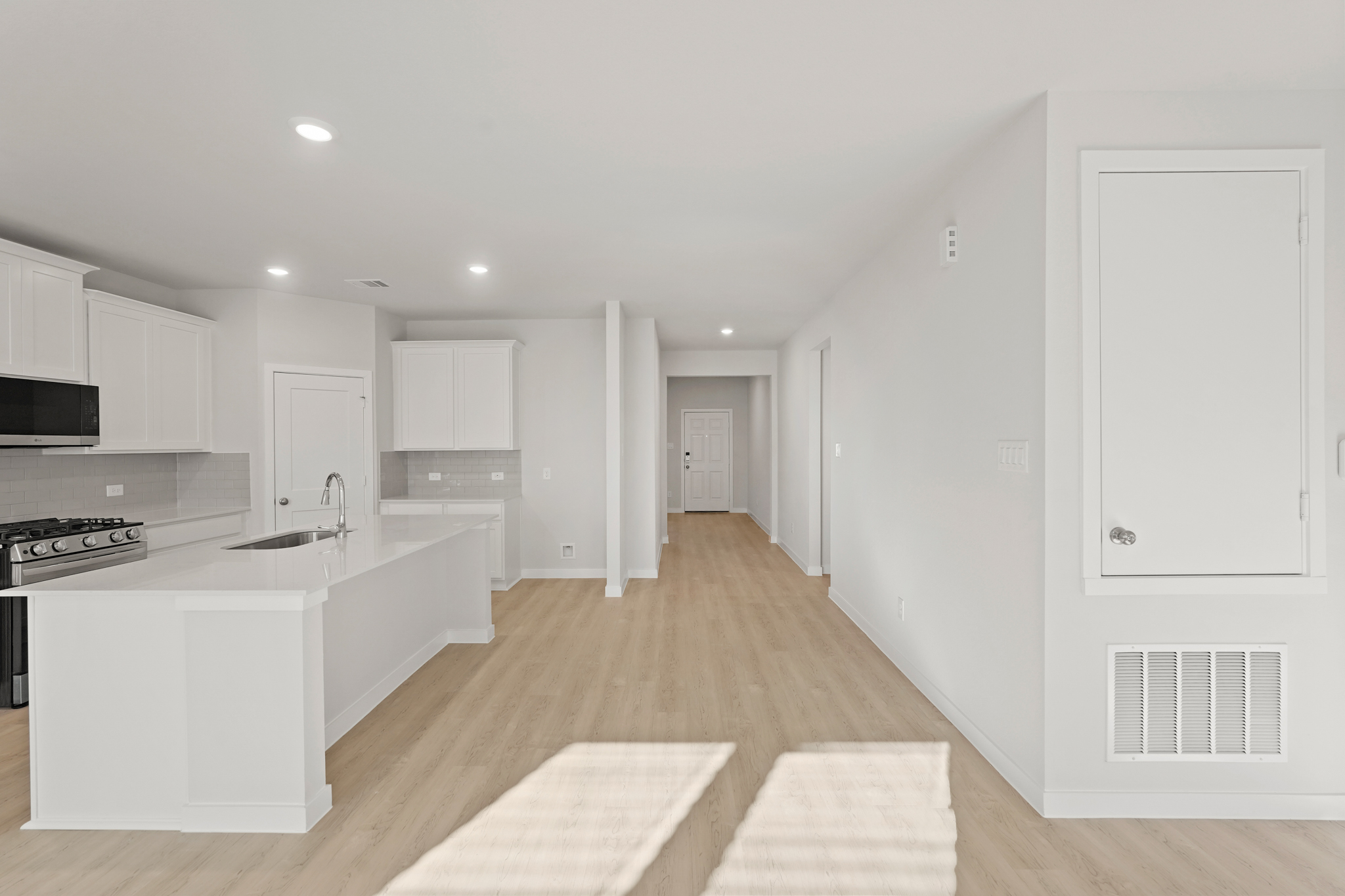 A kitchen with white cabinets.