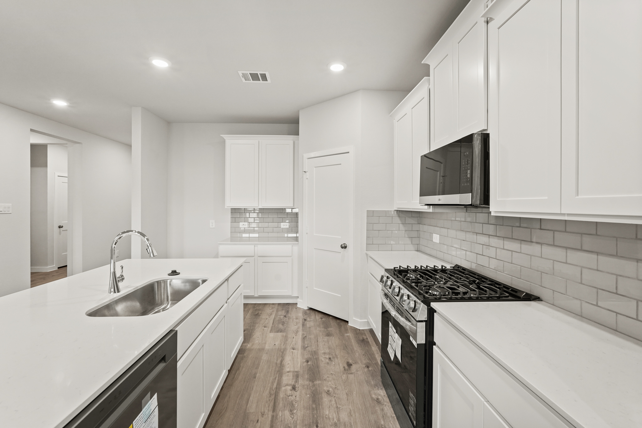 A kitchen with white cabinets.