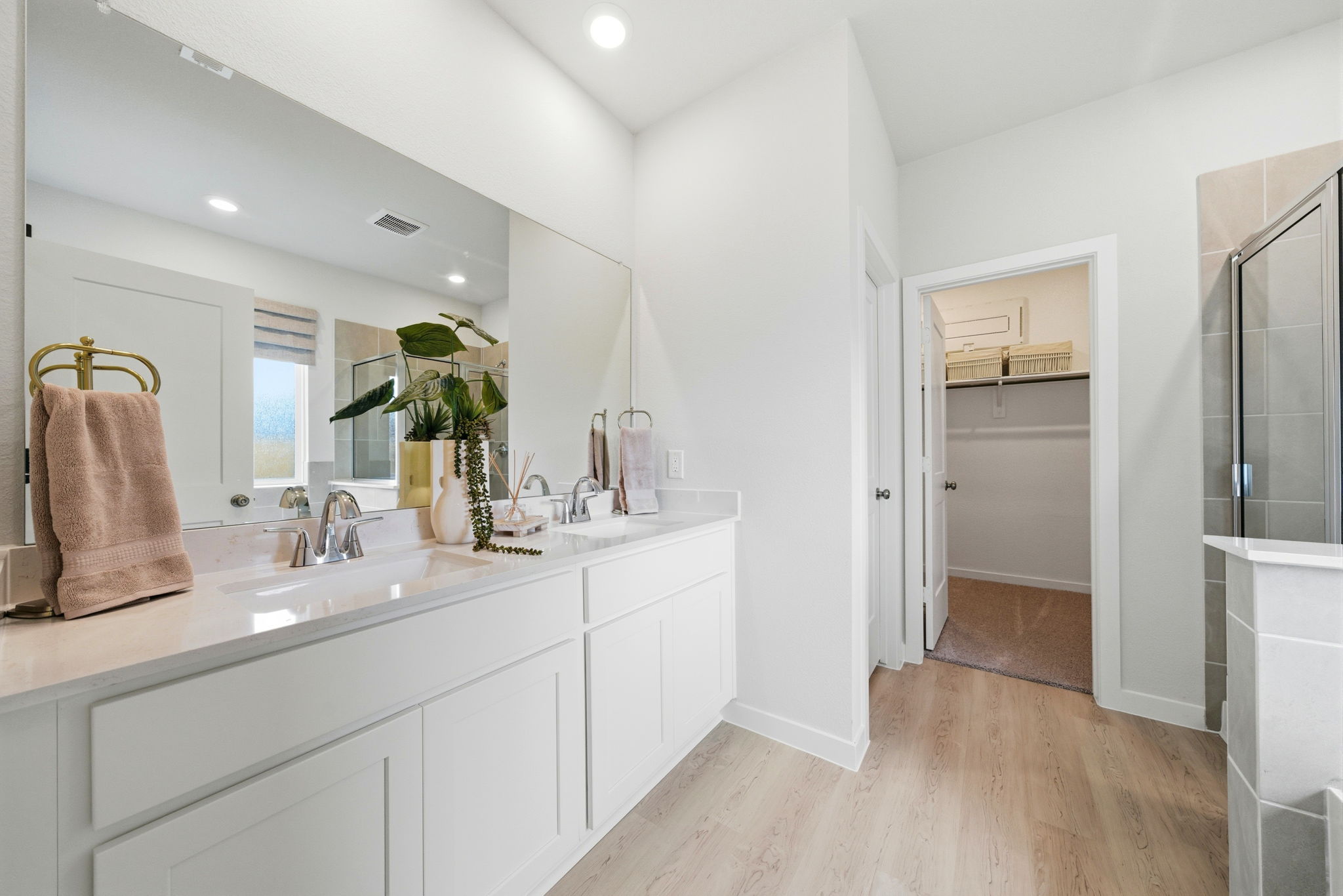 A bathroom with white cabinets.