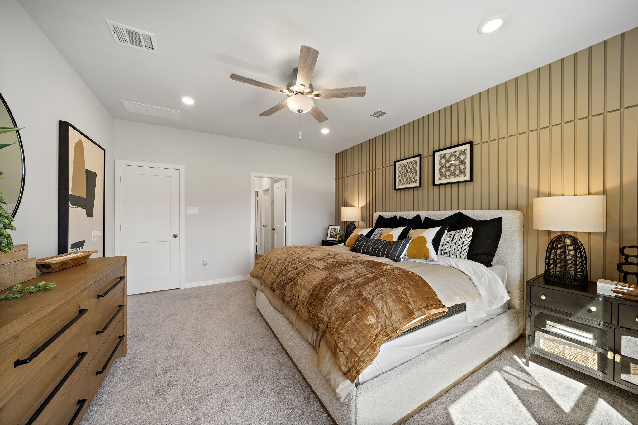A bedroom with a bed and a fan.