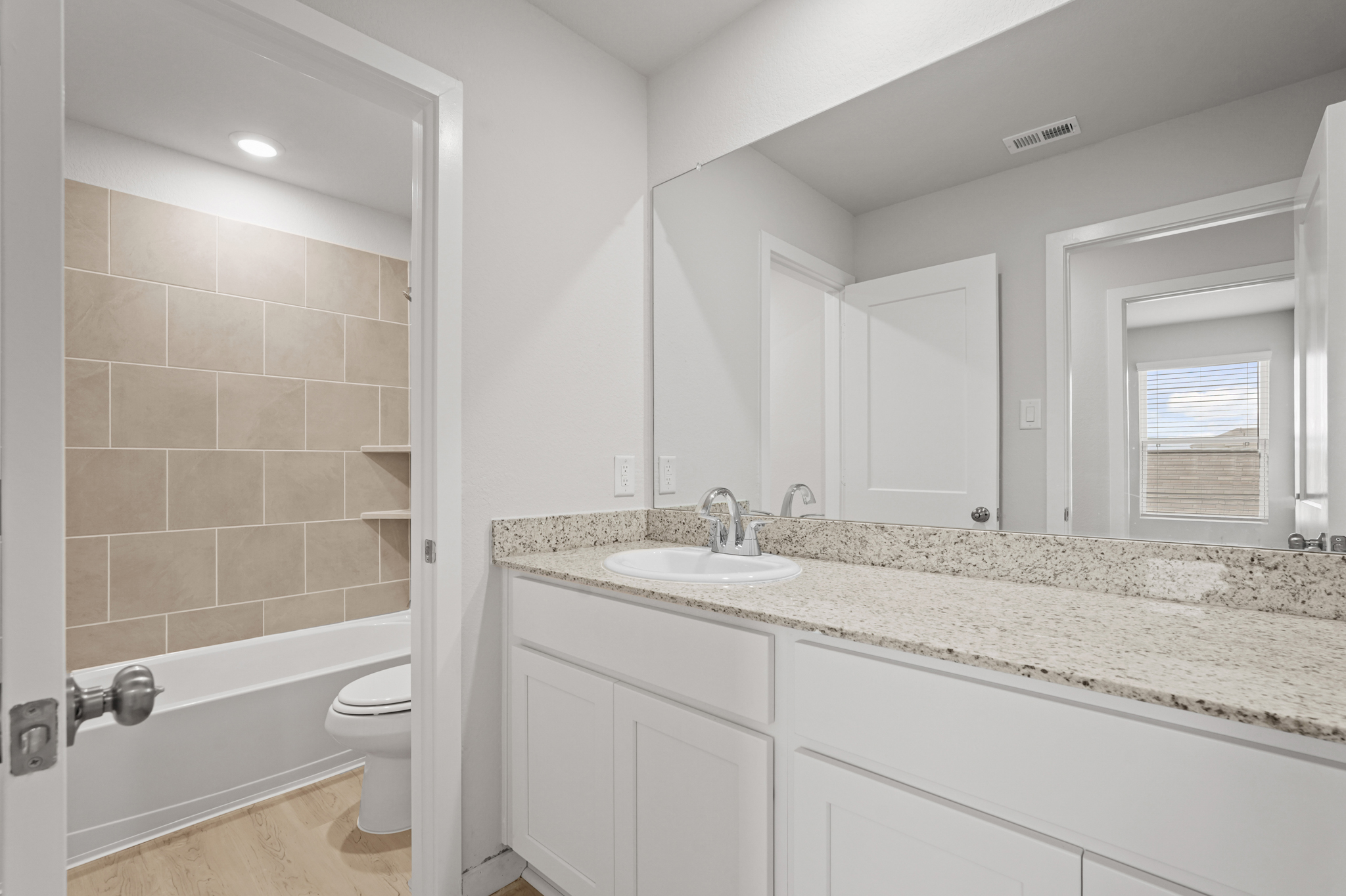 A bathroom with a marble countertop.
