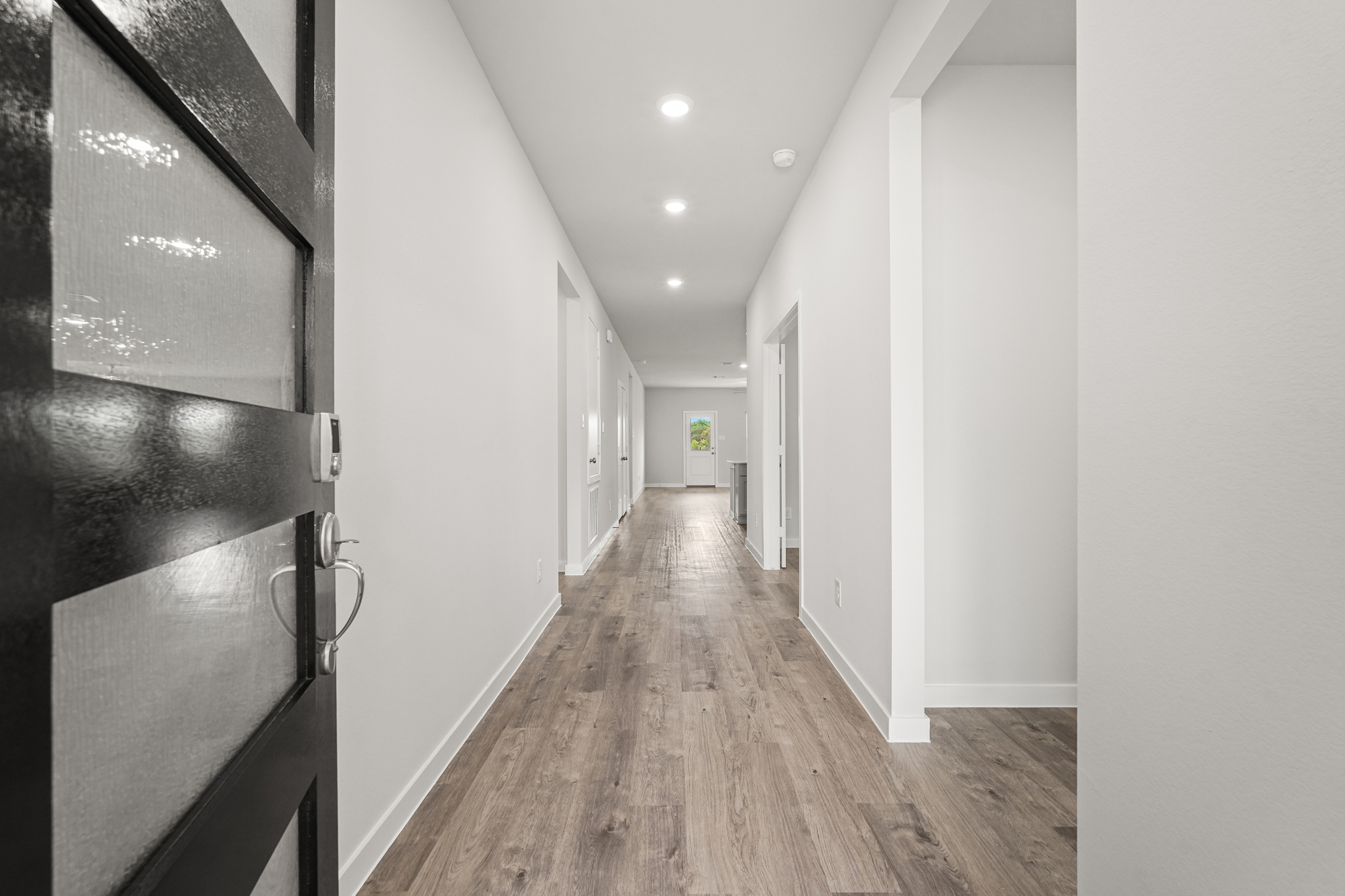 A hallway with white walls.