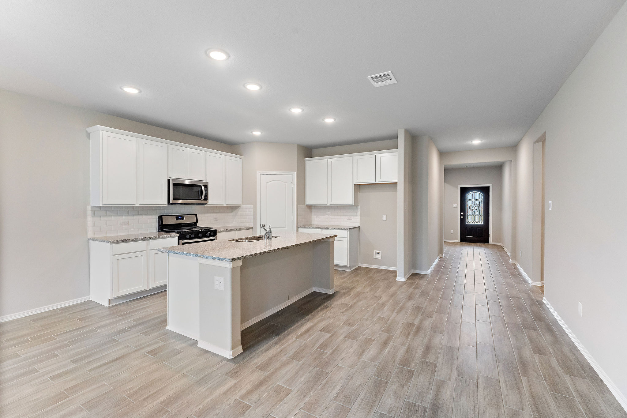 A kitchen with white cabinets.