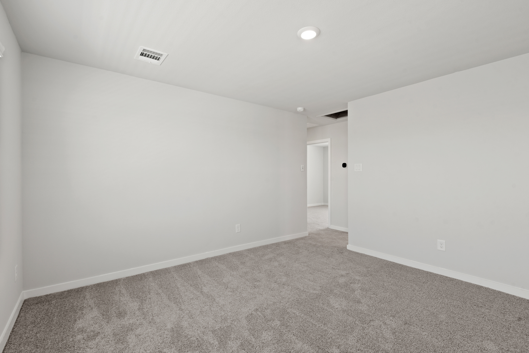 A hallway with white walls.