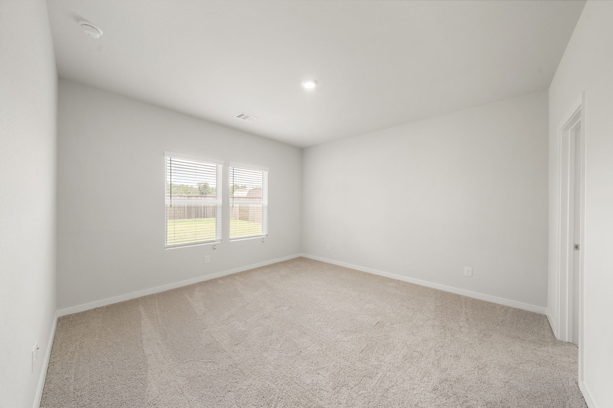 A room with a window and a door.