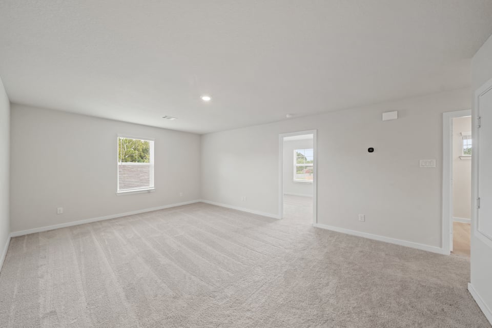 A room with a carpet and a rug.