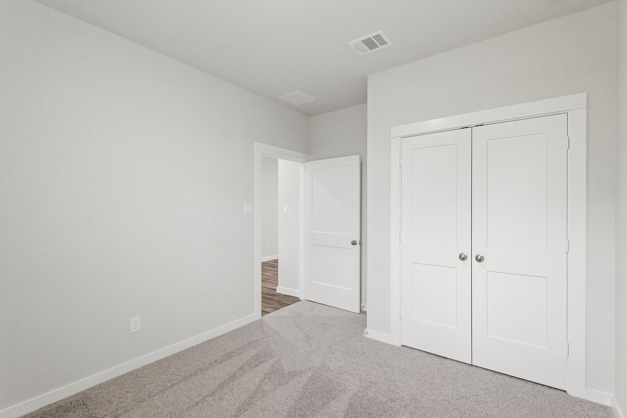 A hallway with white doors.