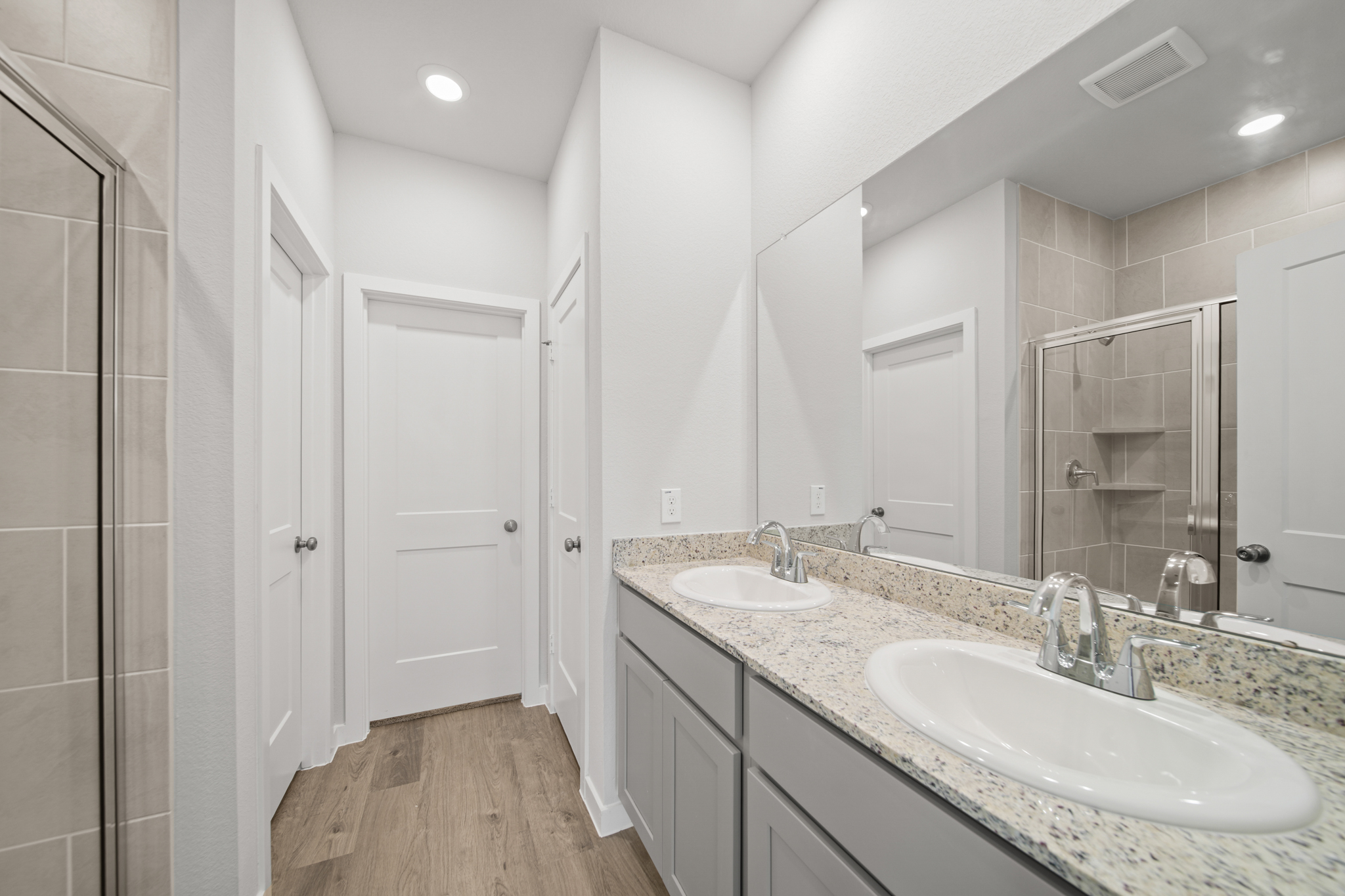 A bathroom with a large mirror.
