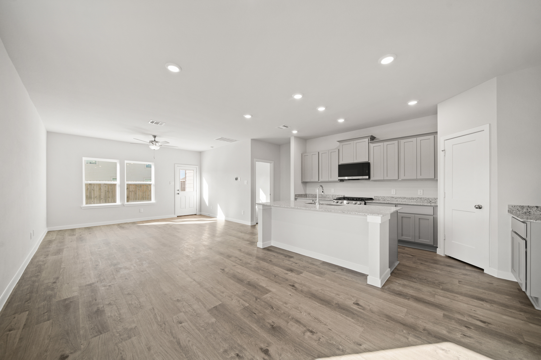 A kitchen with white cabinets.