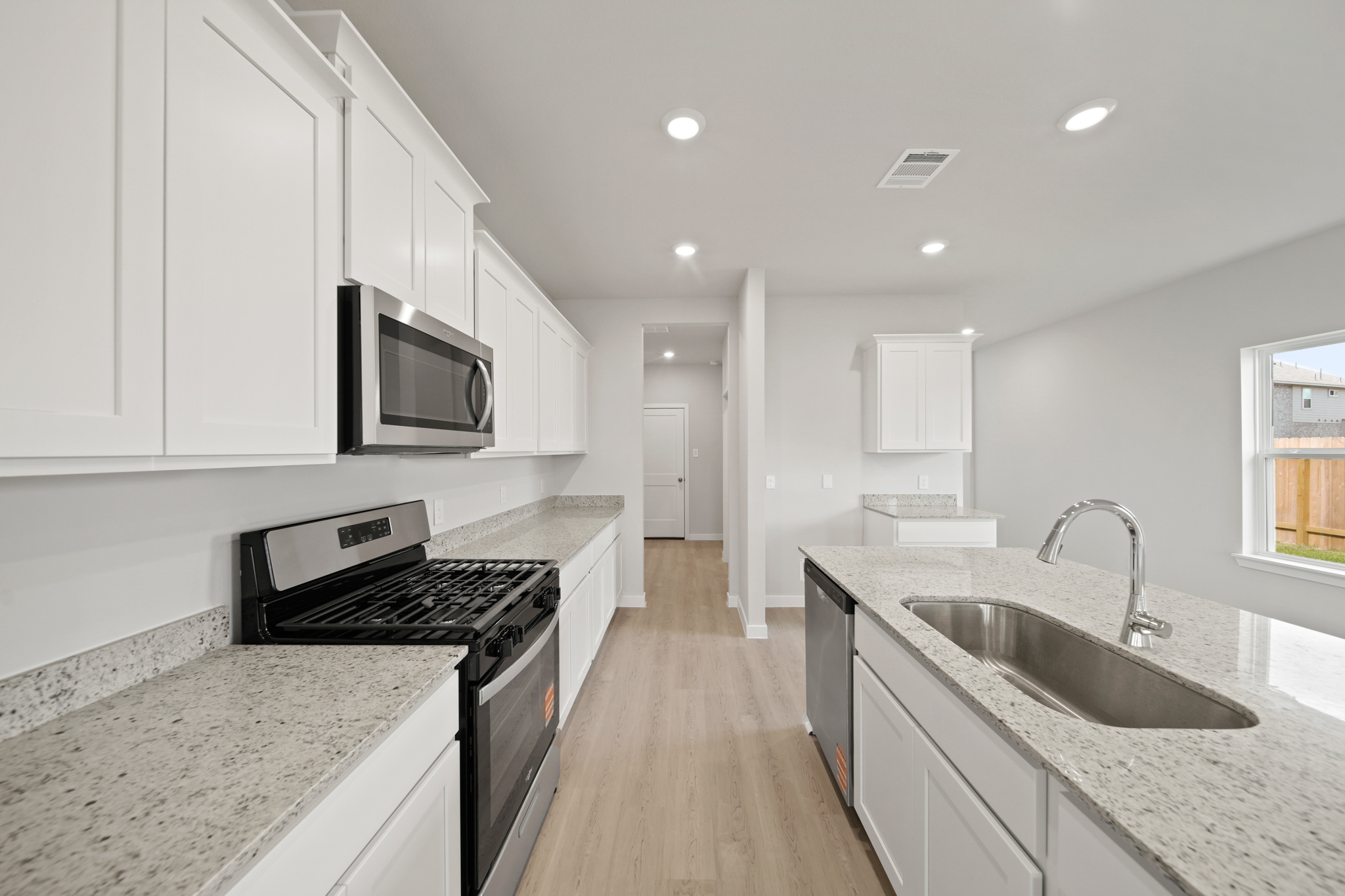 A kitchen with white cabinets.