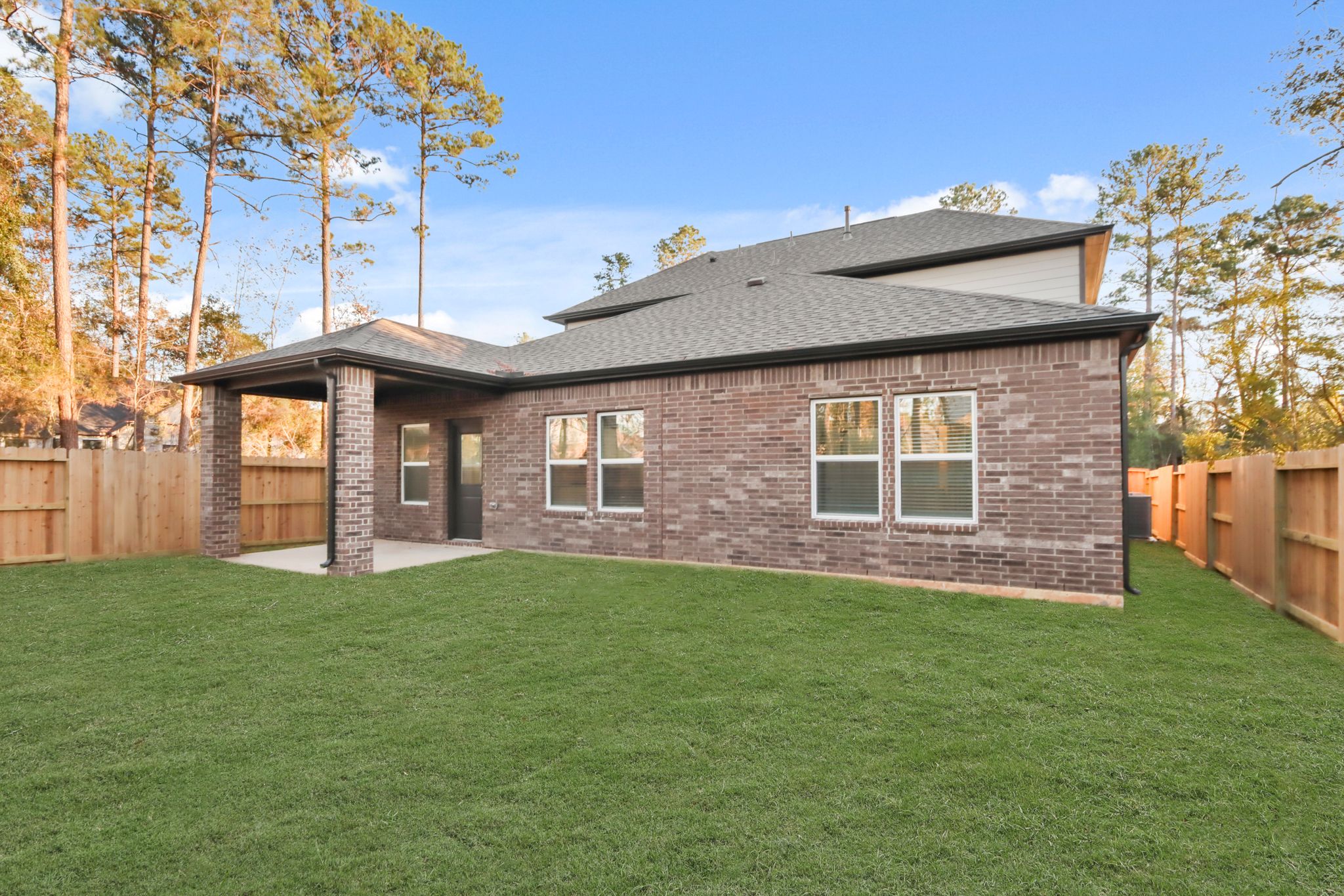 A house with a fence and grass.