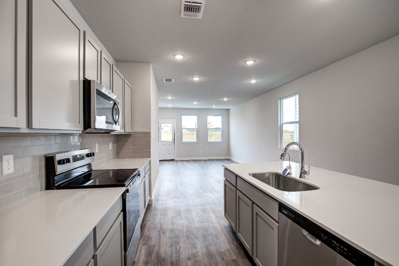 A kitchen with white cabinets.