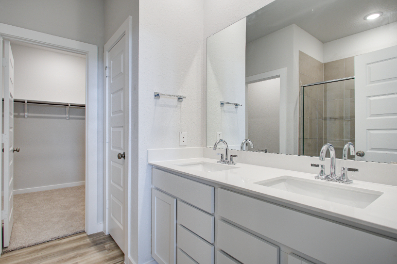 A bathroom with a large mirror.