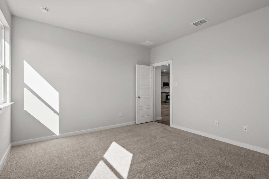 A room with a carpet and a rug.