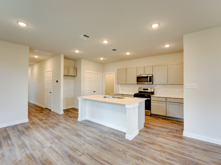 A kitchen with white cabinets.