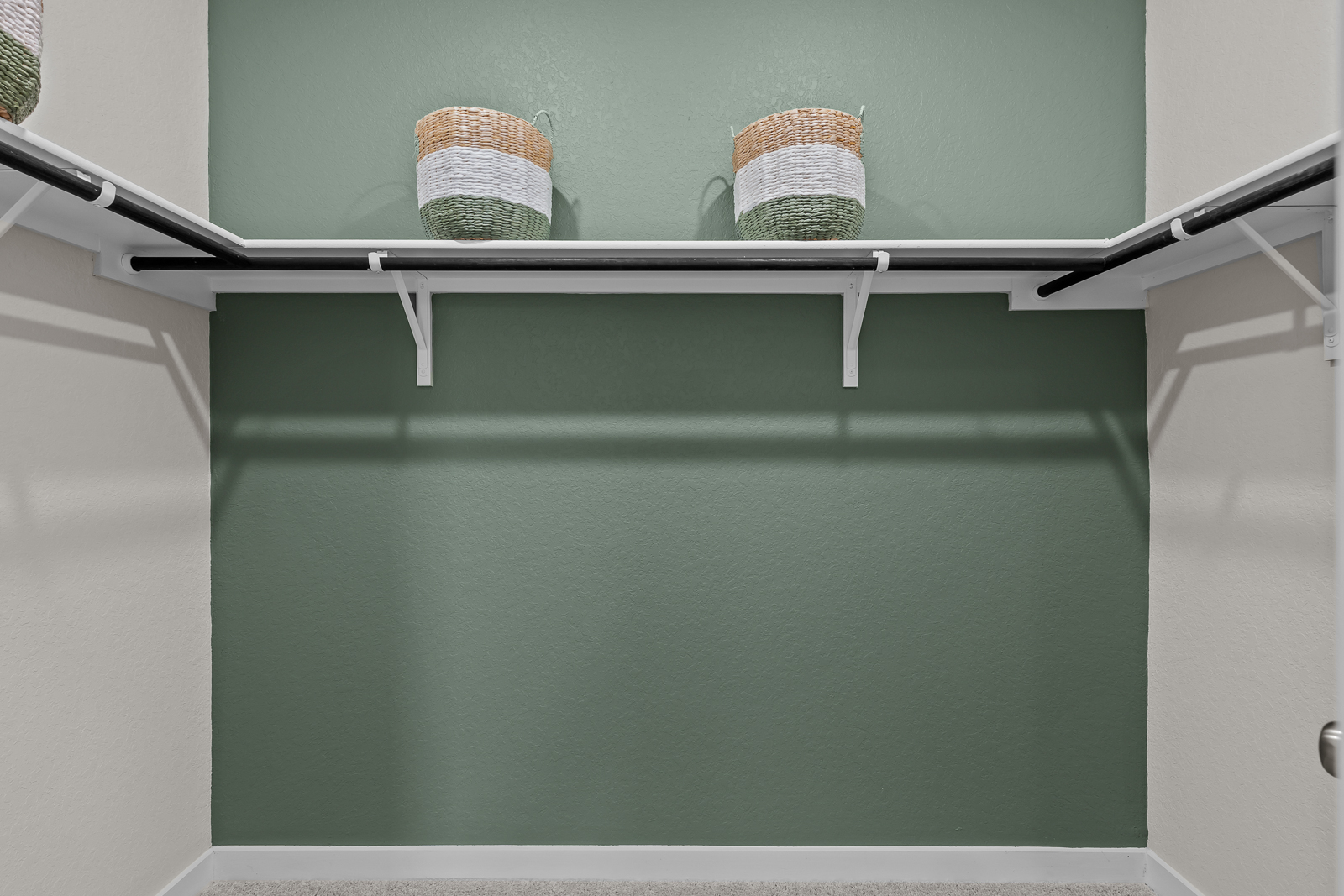 A couple of baskets on a shelf.