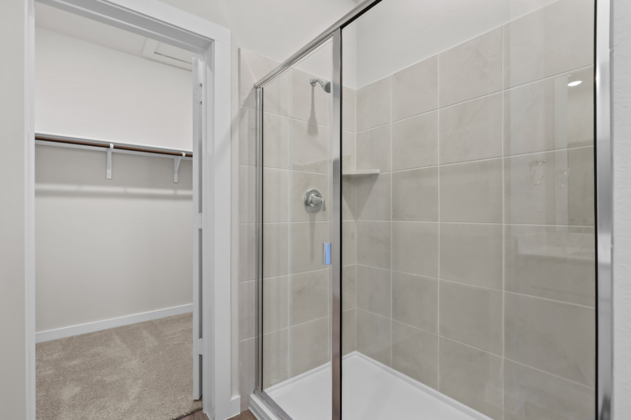 A shower with a glass door.