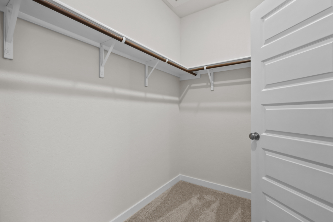A white wall with a white door.