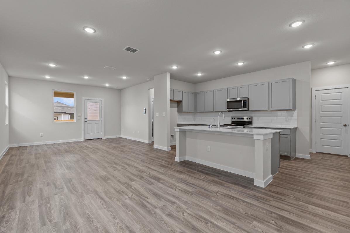 A large kitchen with white cabinets.