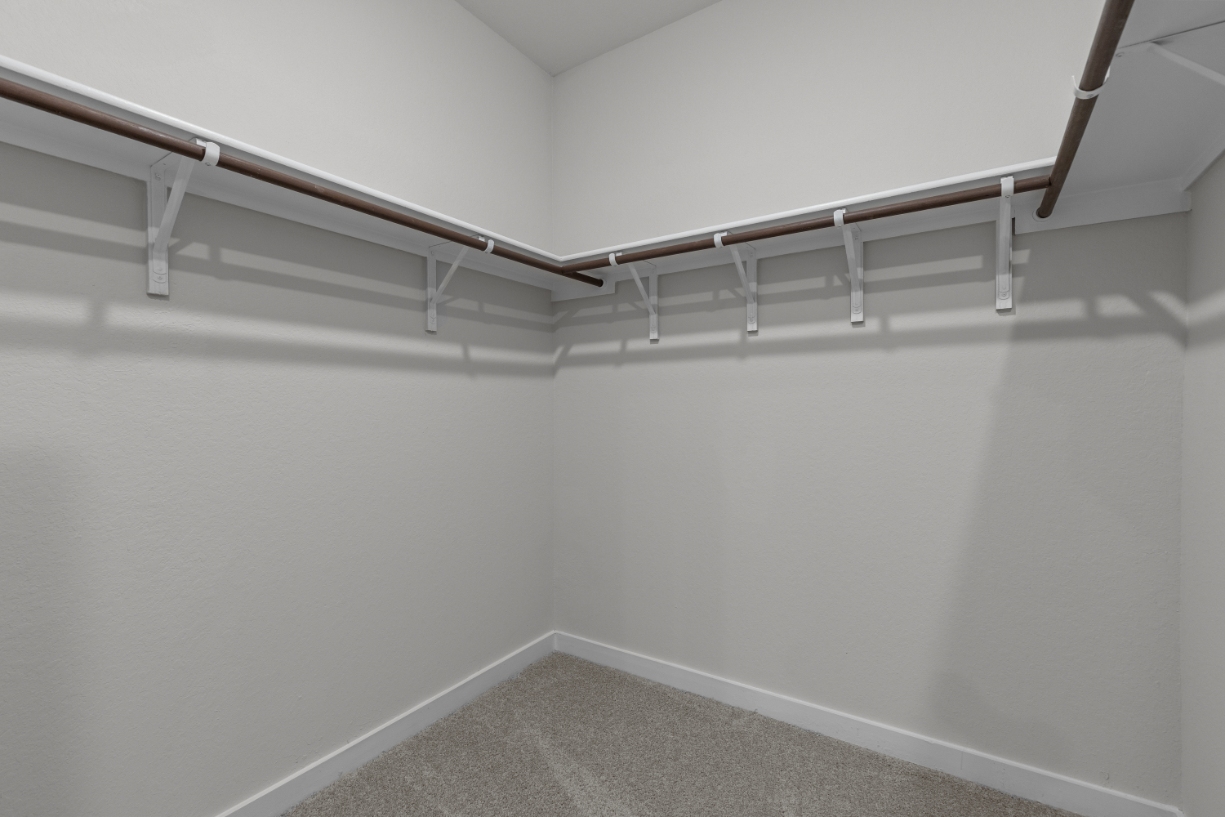 A white wall with a metal railing.