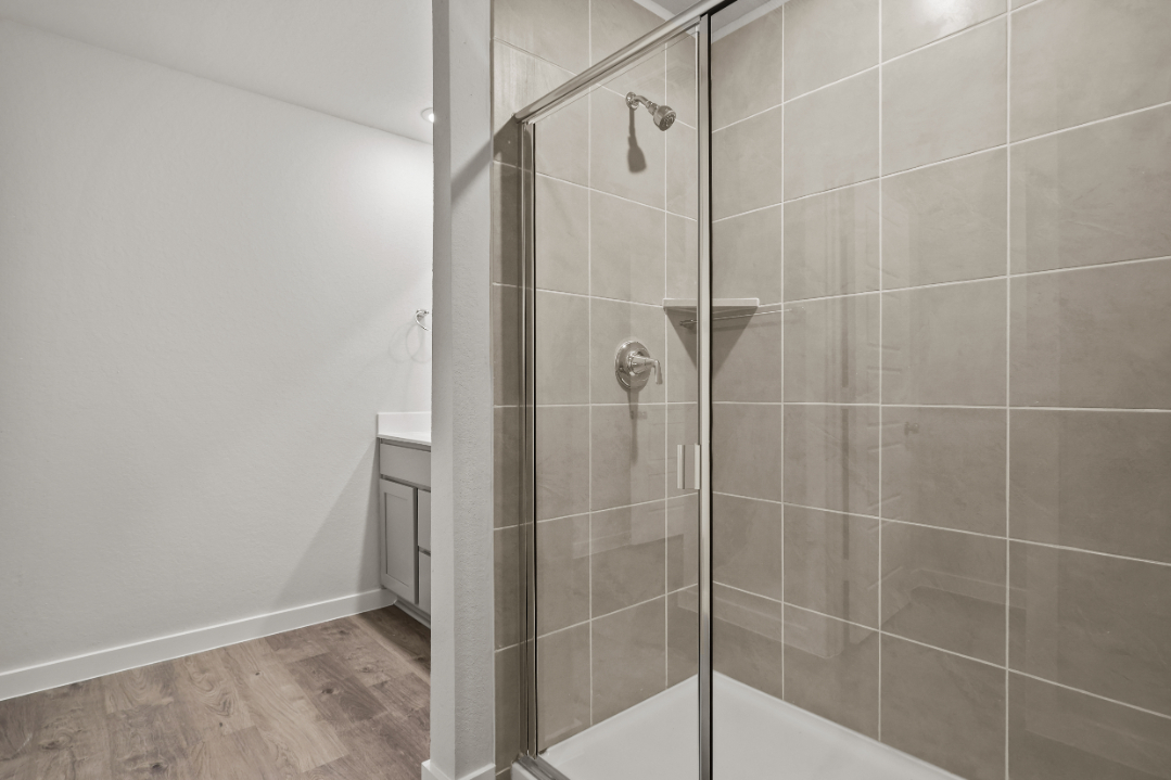 A shower with a glass door.