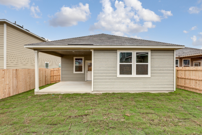 A house with a fence and grass.
