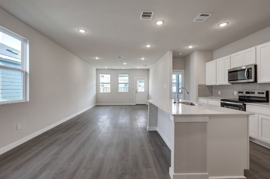 A kitchen with white cabinets.