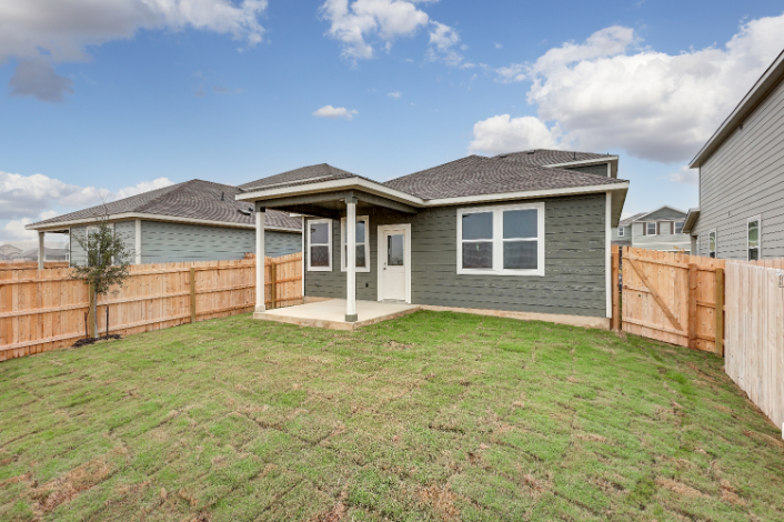 A house with a fence and grass.