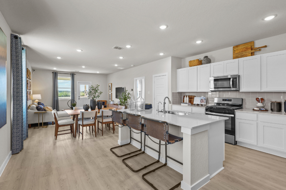A kitchen with white cabinets.