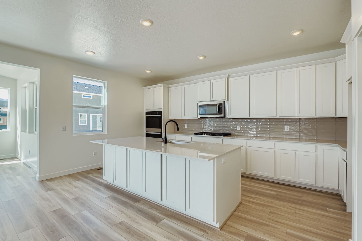 A kitchen with white cabinets.