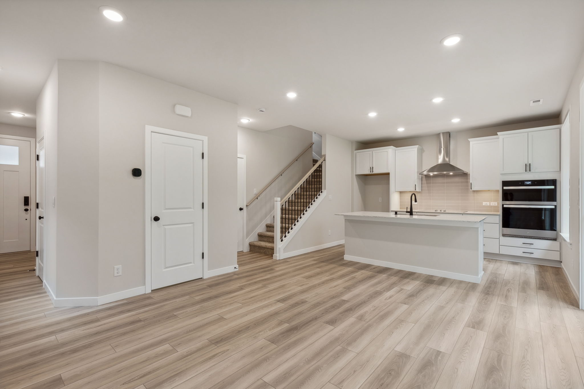 A large kitchen with white cabinets.