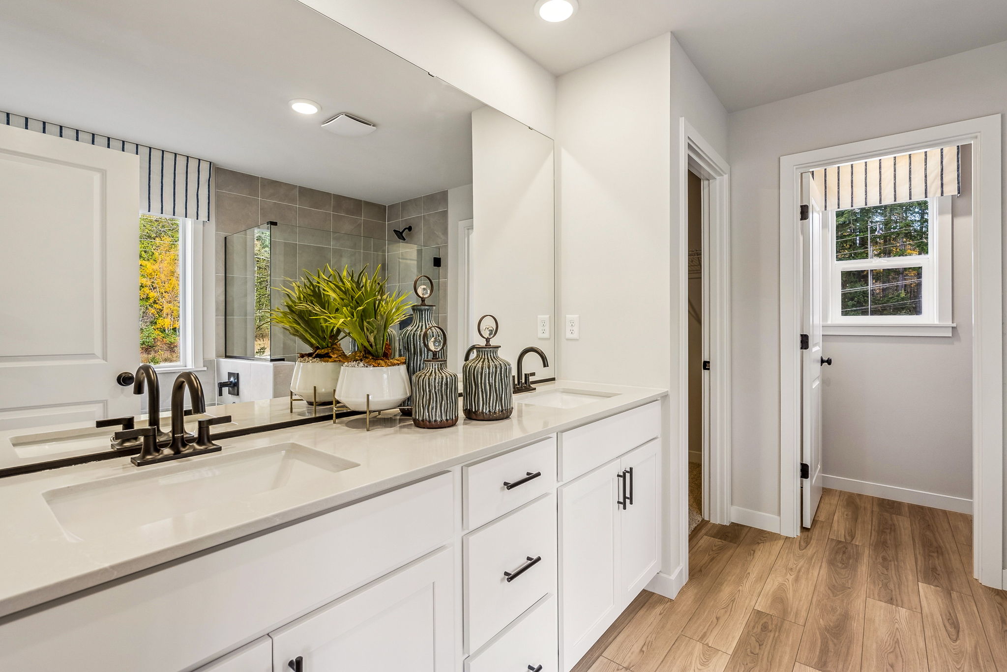 A bathroom with white cabinets.