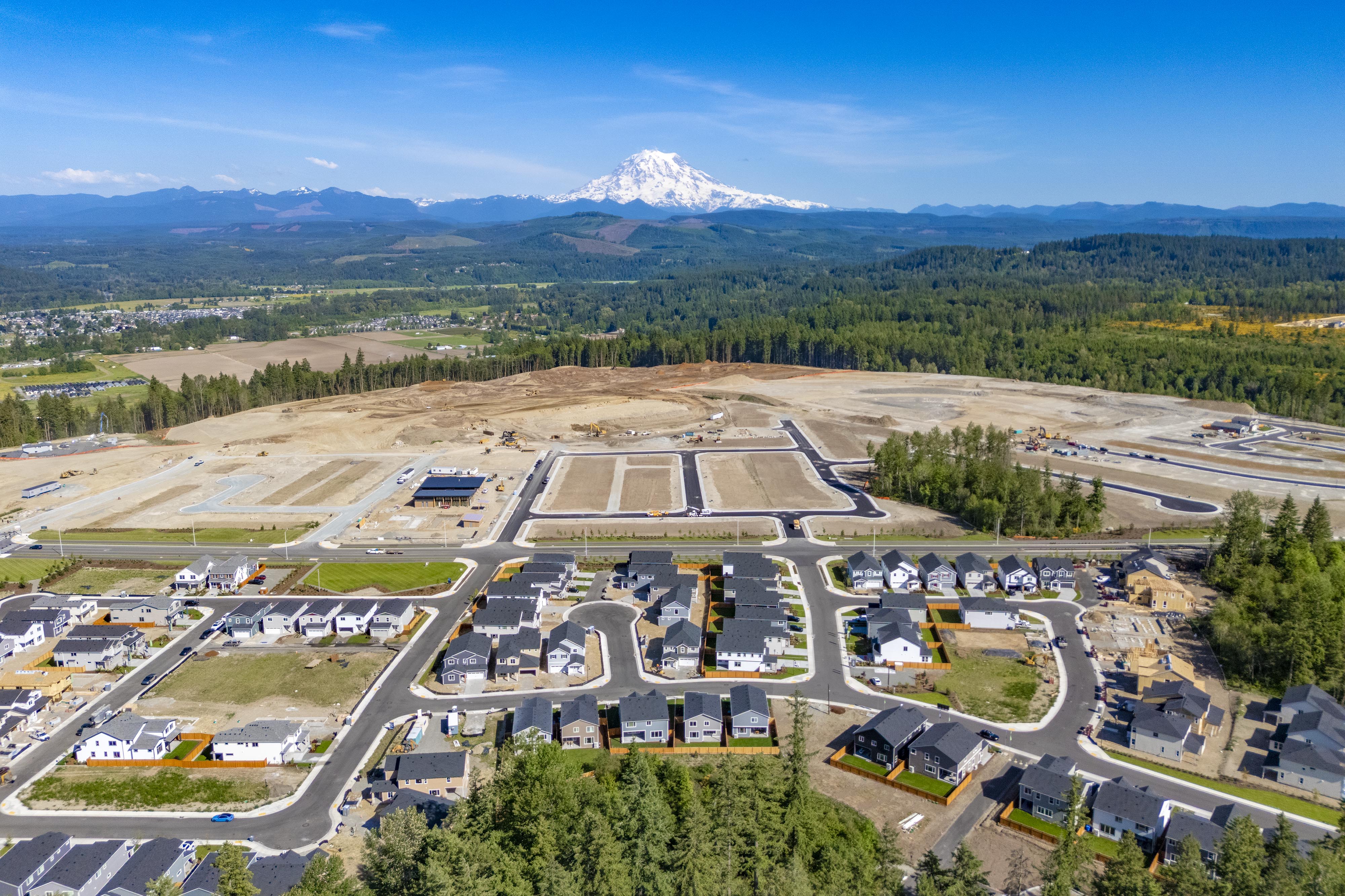 A large parking lot with a mountain in the background.