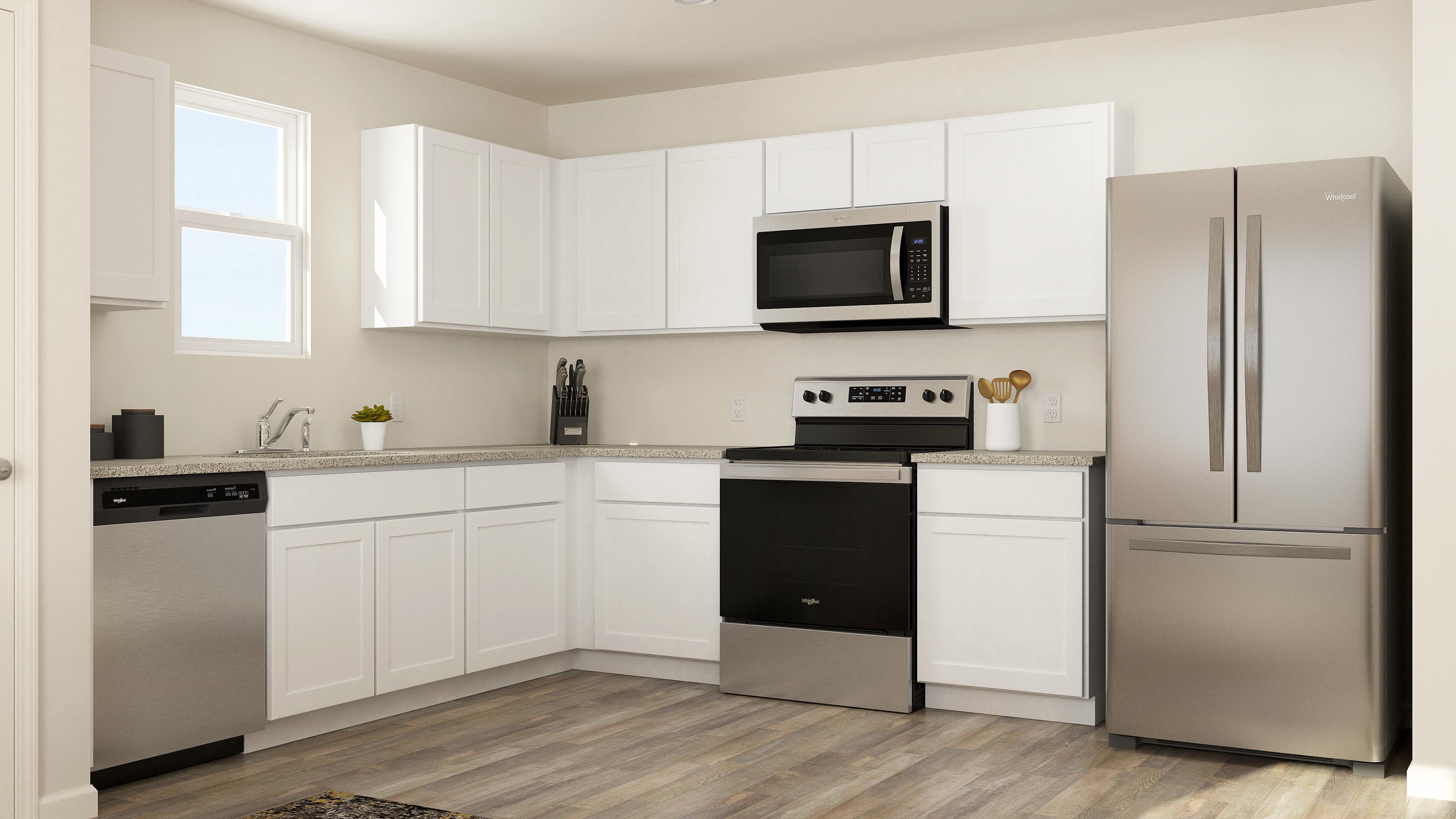 A kitchen with white cabinets.