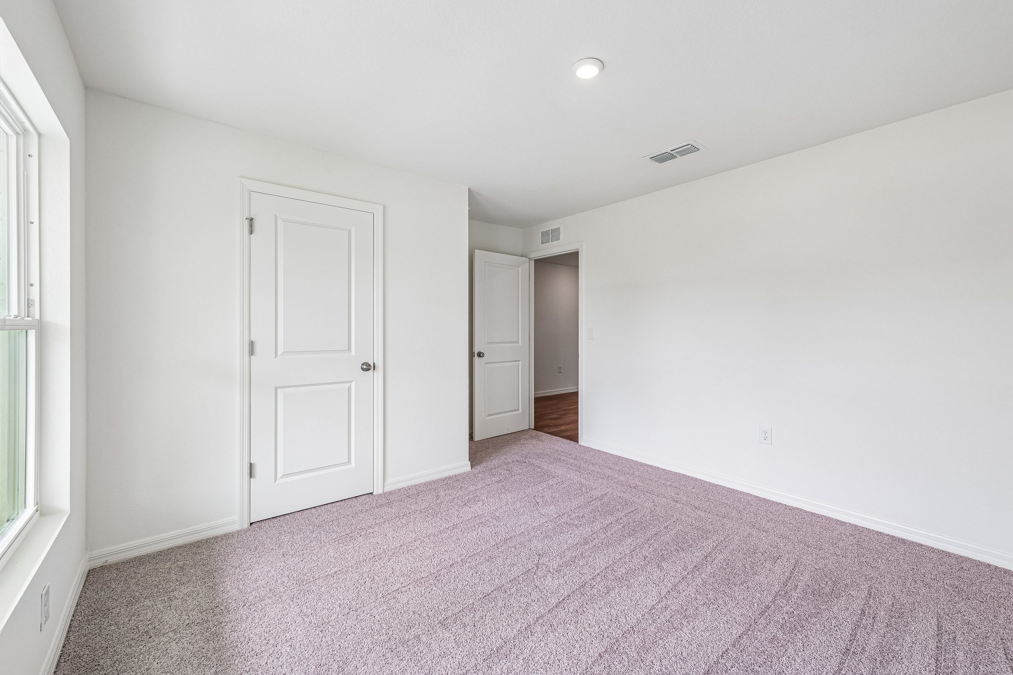 A hallway with white doors.