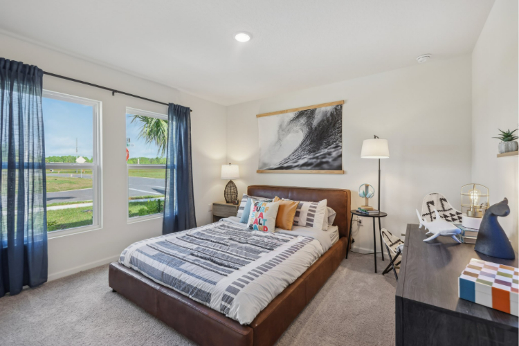 A bedroom with a bed and a window.